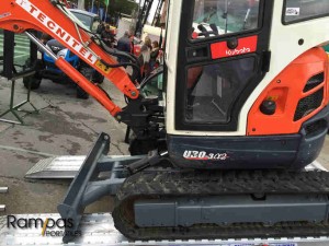 excavadora kubota sobre rampas dentadas